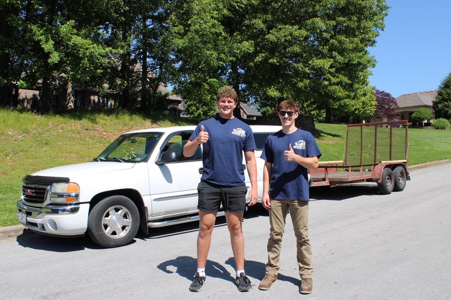 The Queen City Junk Co team with their truck and trailer in Springfield, MO